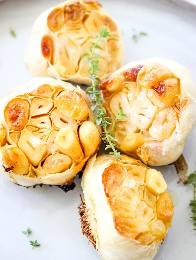 Oven roasted garlic is made with three ingredients- halved garlic, olive oil, and salt. The bulbs are spreadbale, tender, and delicious!