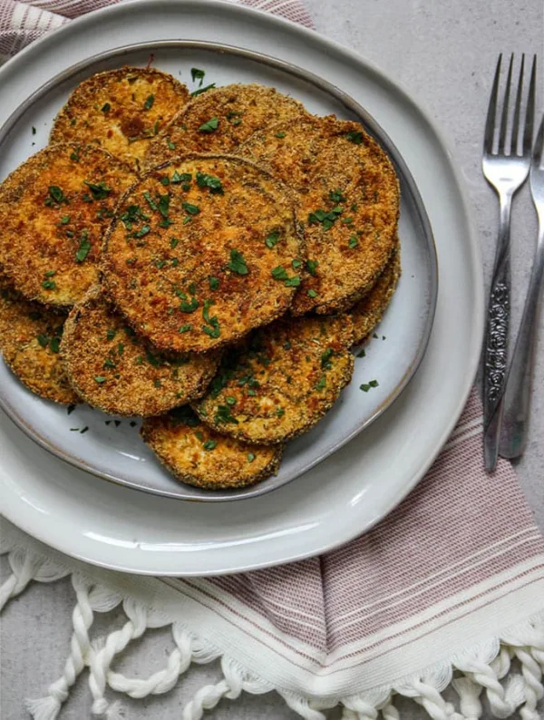 Cripsy baked eggplant slices are breaded with Italian breadcrumbs and parmesan cheese- the perfect flavor combination!