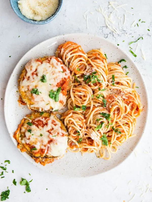 Baked eggplant parmesan is loaded with crispy eggplant disks, layered with marinara sauce, and topped with melty mozzarella cheese- so easy!
